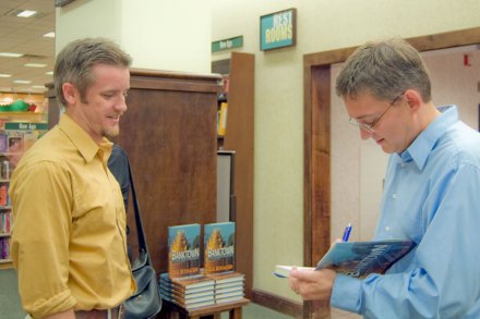 Rick Rothacker signs a copy of Banktown for a reader.
